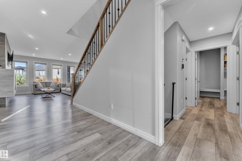 Hardwood-style flooring extends through the main living area - 17551 64 Street, Edmonton, AB 