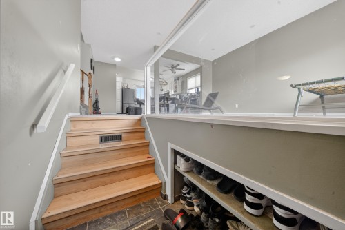 Natural wood-finish staircase with white handrail - 2832 35 Street, Edmonton, AB 