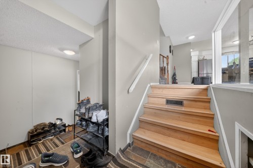 Hardwood staircase with painted risers and a white handrail - 2832 35 Street, Edmonton, AB 