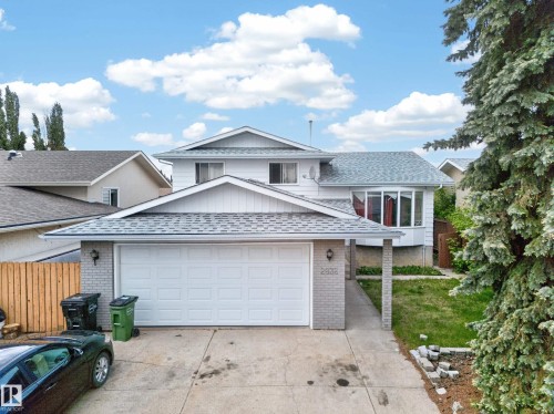 Two-story residence featuring a front-facing attached garage with a double-wide driveway - 2832 35 Street, Edmonton, AB 