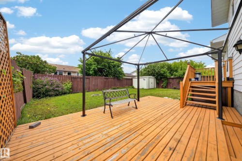 Expansive wooden deck featuring a black metal gazebo frame - 2832 35 Street, Edmonton, AB 