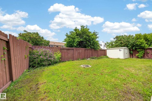 Expansive backyard featuring a fenced perimeter, established trees, and a storage shed - 2832 35 Street, Edmonton, AB 