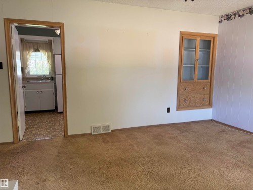Built-in cabinetry with glass-front upper doors and two lower drawers - 5511 50 St, Tofield, AB 