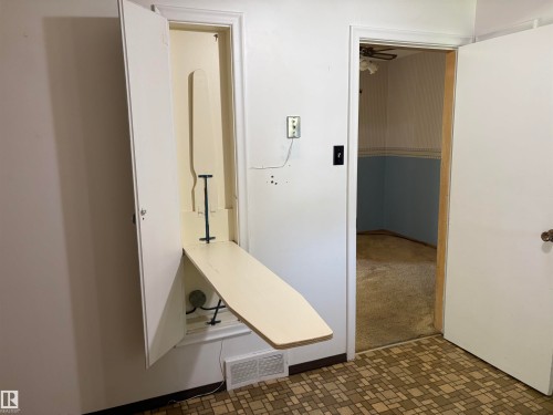 Built-in ironing board within a wall niche - 5511 50 St, Tofield, AB 