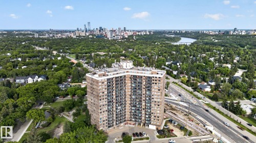 High-rise residential building featuring multiple levels of private balconies, a flat roofline, and an integrated parking area - 412 13910 Stony Plain Road, Edmonton, AB 