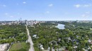 Expansive aerial perspective showcasing a cityscape, a winding river with a bridge, and a broad tree-lined road - 412 13910 Stony Plain Road, Edmonton, AB 