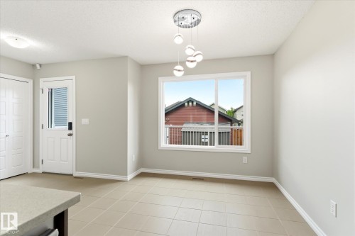 Tiled flooring and light-toned walls create a neutral backdrop - 9039 219 Street, Edmonton, AB 