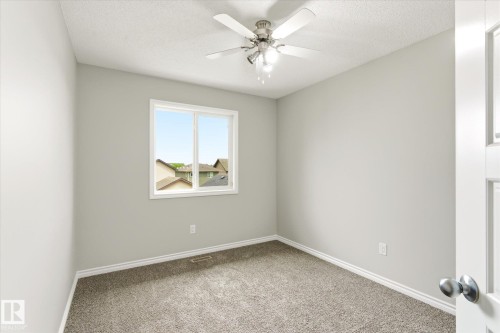 Neutral-toned walls and plush gray carpet define this room - 9039 219 Street, Edmonton, AB 