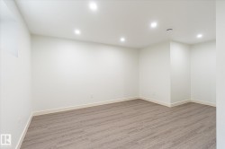 Spacious room featuring light wood-finish flooring, recessed ceiling lighting, and neutral wall tones - 