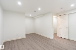 Room featuring wood-finish flooring, recessed lighting, white walls, and white trim - 