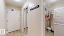 Entryway featuring tile flooring, a mirrored closet with sliding doors, and a coat rack - 201 11408 108 Avenue, Edmonton, AB 
