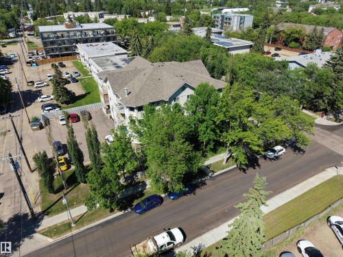 Two-story multi-unit structure featuring a gabled roof and multiple balconies - 201 11408 108 Avenue, Edmonton, AB 