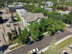 Two-story multi-unit structure featuring a gabled roof and multiple balconies - 