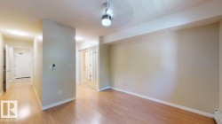 Open-concept room featuring wood-finish flooring, light neutral wall paint, and a semi-flush ceiling light fixture - 