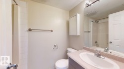 Bathroom featuring a shower-tub combination, single vanity with integrated sink, stone-look countertop, and a wall-mounted medicine cabinet - 