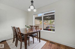 Bright interior space with wood-finish flooring and white baseboards - 