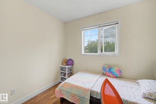 Room featuring wood-finish flooring, a white window frame, and neutral-toned walls - 710 Glenwright Court, Edmonton, AB 