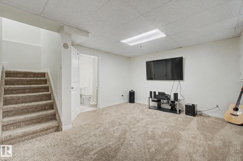 Carpeted lower level recreation space featuring a bright white ceiling, light neutral walls, and recessed lighting - 710 Glenwright Court, Edmonton, AB 