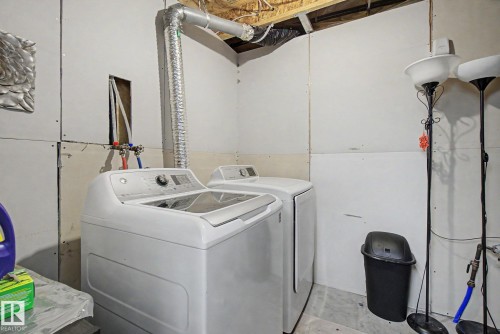 Utility area featuring exposed ceiling joists, white drywall, and concrete flooring - 710 Glenwright Court, Edmonton, AB 
