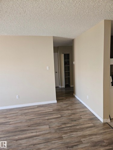 Wood-finish flooring throughout, complemented by neutral wall paint and white baseboards - 301 10615 110 Street Nw, Edmonton, AB 