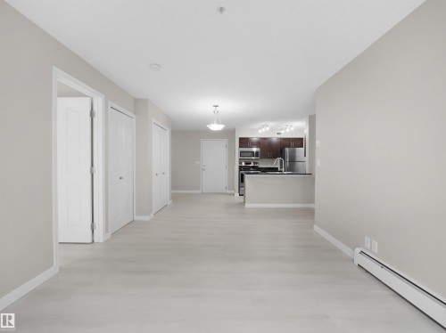 Open concept living space with light wood-finish flooring - 220 12035 22 Avenue, Edmonton, AB 