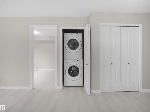Stacked washer and dryer unit within a dedicated closet - 220 12035 22 Avenue, Edmonton, AB 