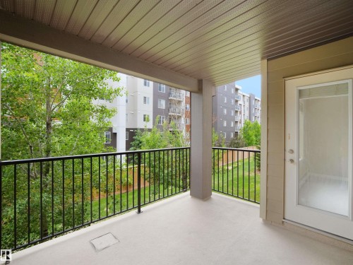 Private balcony featuring a concrete surface and black metal railing - 220 12035 22 Avenue, Edmonton, AB 