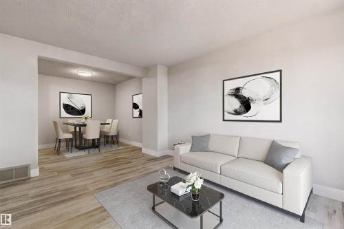 Open-concept living and dining areas featuring wood-finish flooring, recessed lighting, and crisp white walls - 75 Mcleod Place, Edmonton, AB 