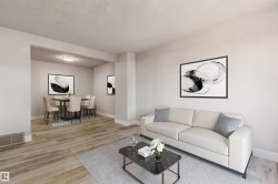 Open-concept living and dining areas featuring wood-finish flooring, recessed lighting, and crisp white walls - 