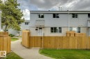 Two-story townhome with light-colored siding and a contrasting stucco foundation - 75 Mcleod Place, Edmonton, AB 