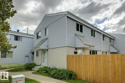 Two-story townhouse exterior with light grey siding and a partial stucco finish - 75 Mcleod Place, Edmonton, AB 
