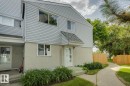 Light-colored siding exterior with a contrasting stucco foundation - 75 Mcleod Place, Edmonton, AB 