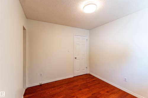 Hardwood flooring, crisp white walls, and a recessed doorway - 16524 116 Street, Edmonton, AB 