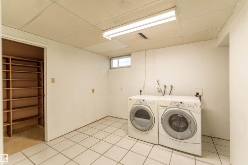 Laundry area featuring white ceramic tile flooring and a drop ceiling - 16524 116 Street, Edmonton, AB 
