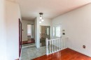 Entryway featuring a decorative glass front door and a three-bulb ceiling fixture - 16524 116 Street, Edmonton, AB 