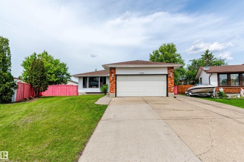 Single-story residence featuring white siding and a brick facade - 16524 116 Street, Edmonton, AB 