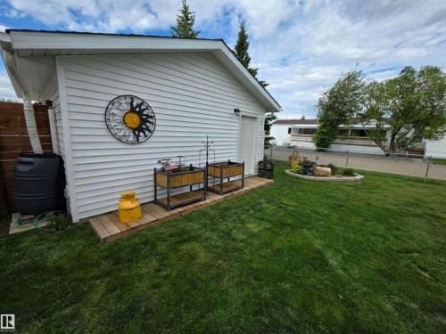 White-sided exterior building with a rain barrel and a wooden deck - 88B 3400 48 Street, Stony Plain, AB 