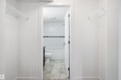 Walk-through closet featuring white wire shelving - 