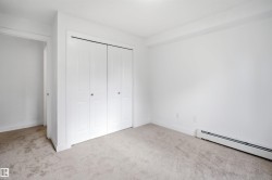 Neutral-toned carpeting paired with white walls, baseboards, and trim - 