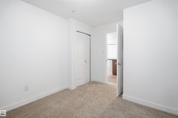 Carpeted room with white walls, white baseboards, and a bi-fold closet door - 