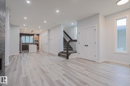 Open concept living space featuring light wood-finish flooring and recessed lighting throughout - 10628 81 Street Nw, Edmonton, AB 