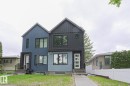 Contemporary duplex featuring a striking two-tone facade with dark gray vertical siding and blue stucco - 10628 81 Street Nw, Edmonton, AB 