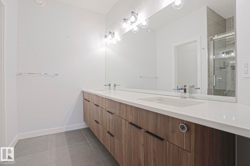 Dual vanity with wood-finish cabinetry and integrated sinks - 10628 81 Street Nw, Edmonton, AB 