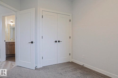 Room featuring light gray wall paint and gray carpeting - 10628 81 Street Nw, Edmonton, AB 