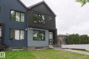 Modern exterior showcasing a multi-tone facade with dark vertical siding and contrasting flat paneling - 10628 81 Street Nw, Edmonton, AB 