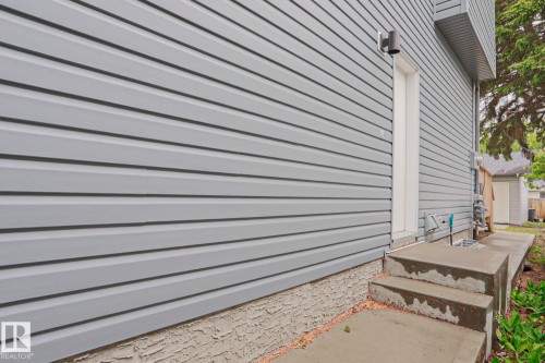 Grey horizontal siding facade with white trim - 10628 81 Street Nw, Edmonton, AB 