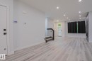 Spacious open-concept room featuring light wood-finish flooring and recessed lighting - 10628 81 Street Nw, Edmonton, AB 