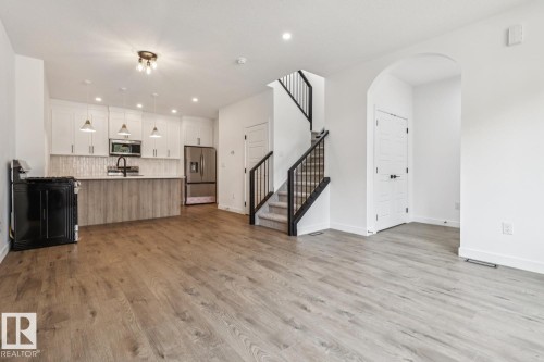Open-concept living space with wood-finish flooring - 11336 130 Street Nw, Edmonton, AB 