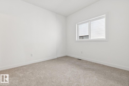Carpeted flooring, white walls, and a window with horizontal blinds - 11336 130 Street Nw, Edmonton, AB 