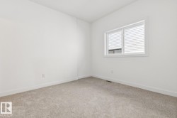 Carpeted flooring, white walls, and a window with horizontal blinds - 